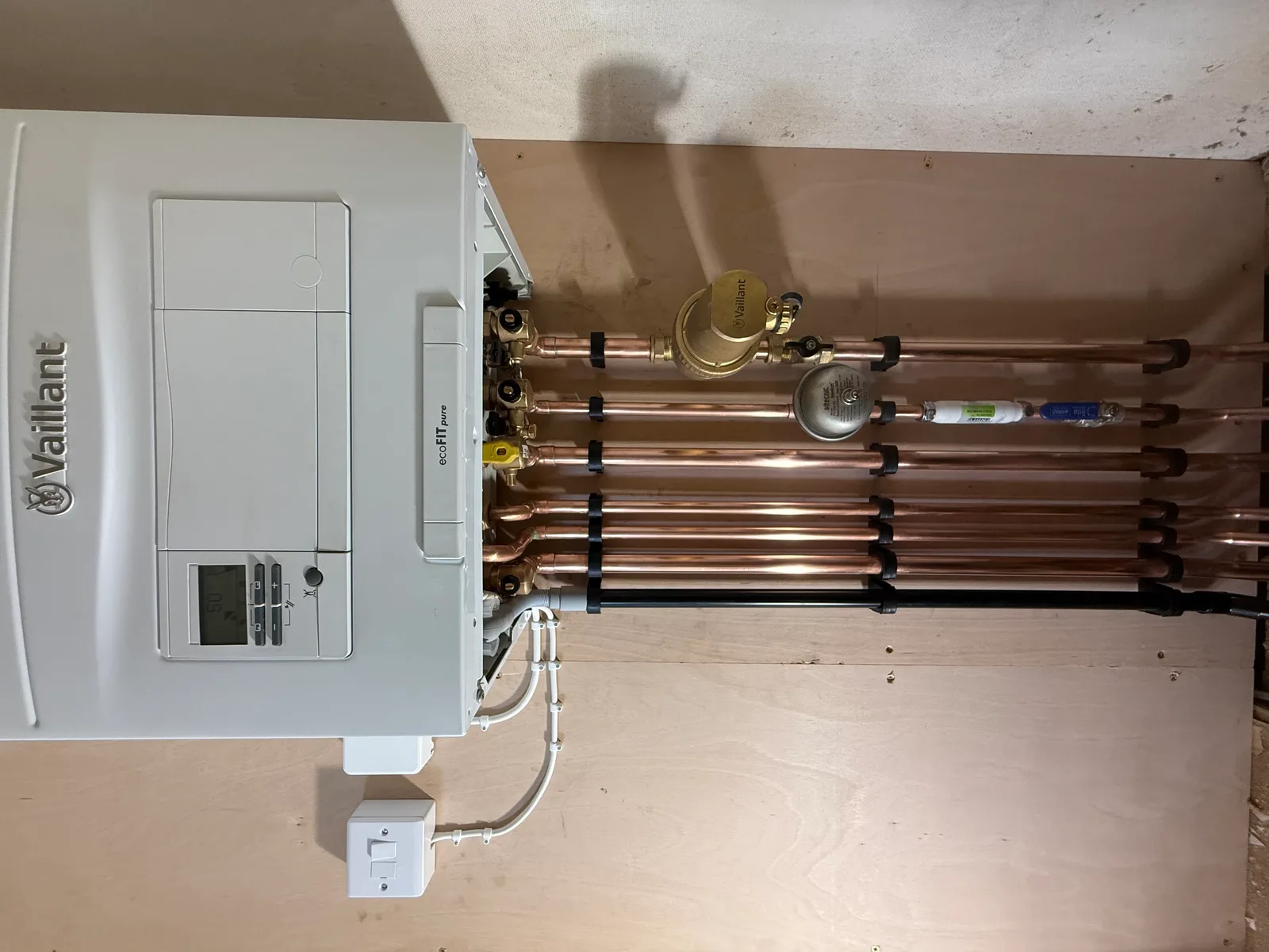 Wall-mounted boiler installation with neat copper pipework